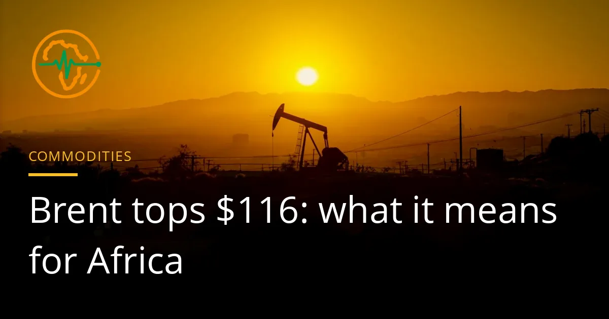 An oil pump jack silhouetted against a hazy orange sunset